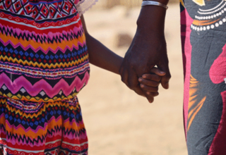 Satiana, 8, holds her grandmother's hand before the trial of her rapist at Ambovombe Court in Madagascar. © UNFPA Madagascar/Mel